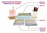 Personalized corporate gift hamper with desk items including a calendar, pen holder, mouse pad and notepad -DEVRAAJ