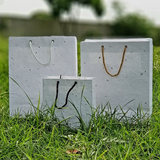 different size of plantable seed paper bags on grass